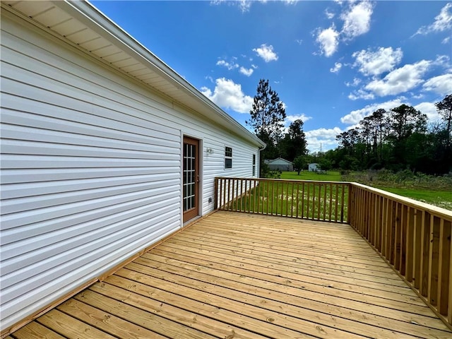 wooden terrace featuring a lawn