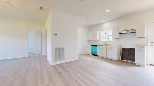 kitchen with a sink, under cabinet range hood, visible vents, and dishwasher