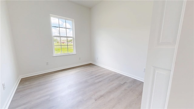 empty room featuring baseboards and wood finished floors