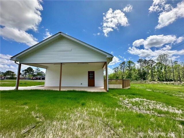 rear view of property with a patio and a lawn