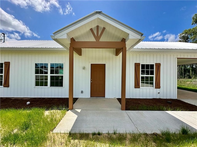 entrance to property featuring metal roof