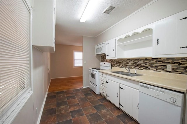 kitchen featuring backsplash, sink, white appliances, a textured ceiling, and white cabinets