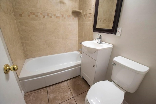 full bathroom featuring toilet, vanity, tiled shower / bath combo, and tile patterned floors