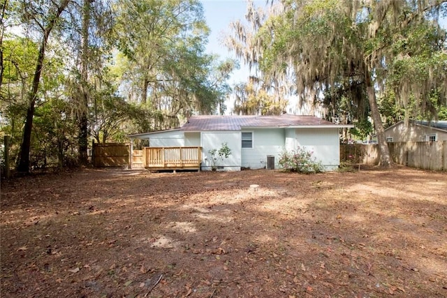 rear view of property featuring a deck