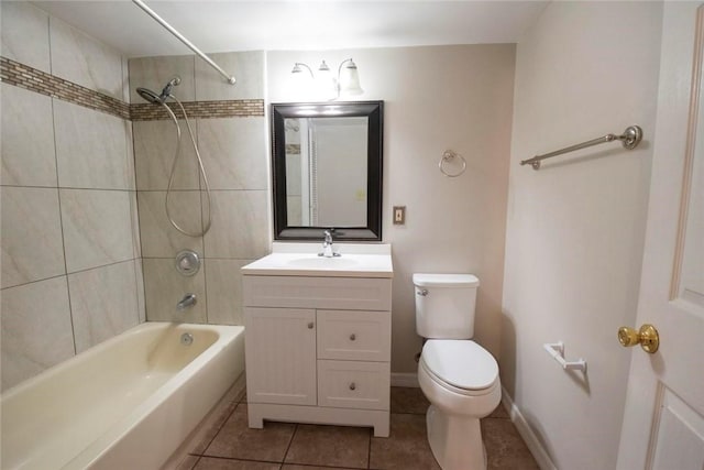 full bathroom featuring toilet, vanity, tiled shower / bath, and tile patterned flooring