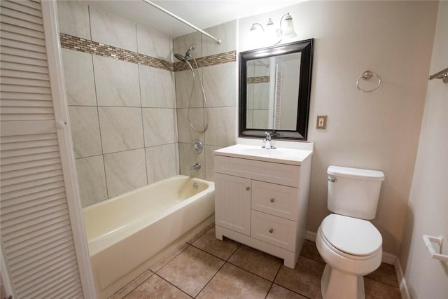 full bathroom featuring toilet, tiled shower / bath combo, tile patterned floors, and vanity