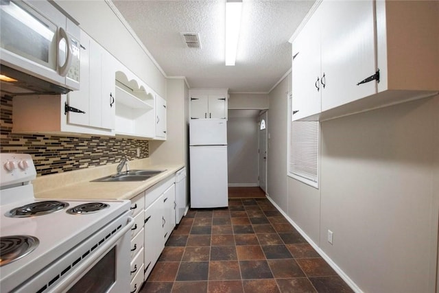 kitchen with decorative backsplash, sink, white appliances, white cabinetry, and a textured ceiling