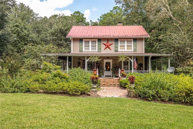 510 Bladen Rd, Brunswick, GA 31523 - country-style home featuring covered porch, a chimney, metal roof, and a front lawn