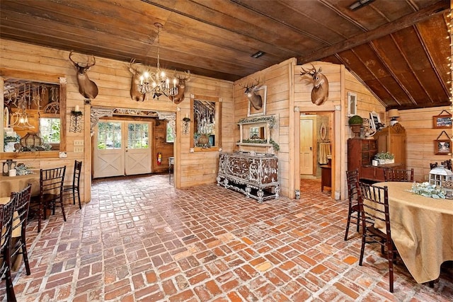 510 Bladen Rd, Brunswick, GA 31523 - dining area with wooden walls, an inviting chandelier, brick floor, wooden ceiling, and vaulted ceiling
