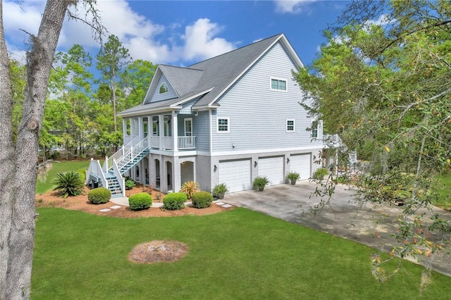 1068 Picnic Ln NE, Townsend, GA 31331 - view of home's exterior with a porch, concrete driveway, an attached garage, stairway, and a yard