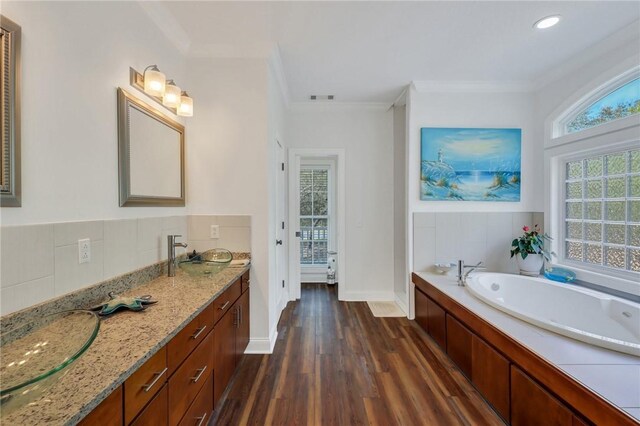 1068 Picnic Ln NE, Townsend, GA 31331 - full bathroom featuring a garden tub, ornamental molding, wood finished floors, and double vanity