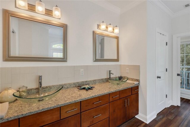 1068 Picnic Ln NE, Townsend, GA 31331 - full bath featuring double vanity, wood finished floors, crown molding, and a sink