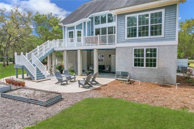 1068 Picnic Ln NE, Townsend, GA 31331 - back of property featuring stucco siding, stairway, central air condition unit, and a patio area