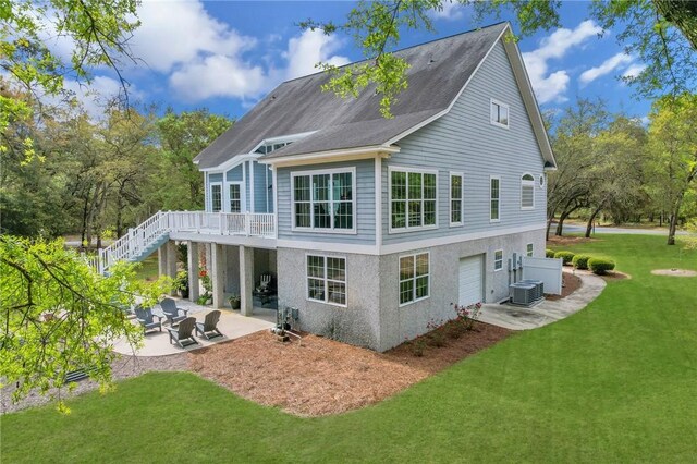1068 Picnic Ln NE, Townsend, GA 31331 - back of house with central air condition unit, a patio area, a lawn, stairway, and a deck