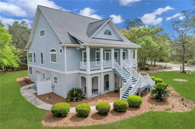 1068 Picnic Ln NE, Townsend, GA 31331 - back of property featuring stairway, a shingled roof, covered porch, and a yard