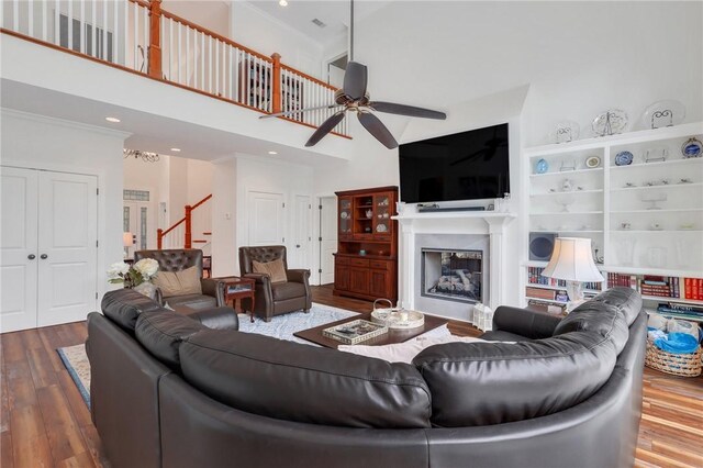 1068 Picnic Ln NE, Townsend, GA 31331 - living area featuring a fireplace, wood finished floors, a high ceiling, and a ceiling fan