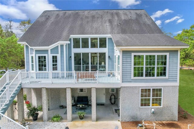 1068 Picnic Ln NE, Townsend, GA 31331 - back of property with a carport, a patio area, stairs, and a shingled roof