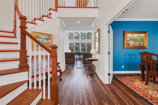1068 Picnic Ln NE, Townsend, GA 31331 - entrance foyer with wood finished floors, stairs, crown molding, and baseboards