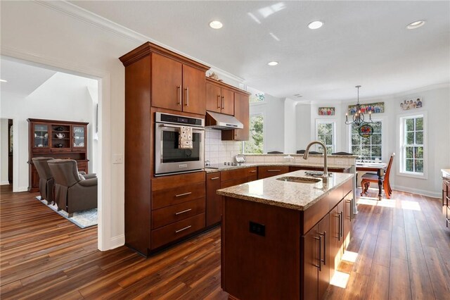 1068 Picnic Ln NE, Townsend, GA 31331 - kitchen featuring light stone countertops, oven, a sink, and dark wood-style flooring