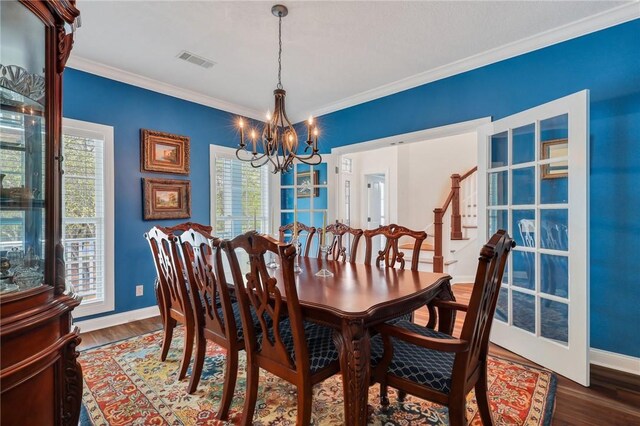 1068 Picnic Ln NE, Townsend, GA 31331 - dining room featuring a wealth of natural light, a notable chandelier, wood finished floors, and visible vents
