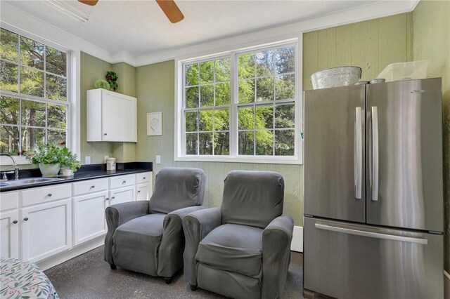 1068 Picnic Ln NE, Townsend, GA 31331 - sitting room with ornamental molding, a ceiling fan, and dark speckled floor