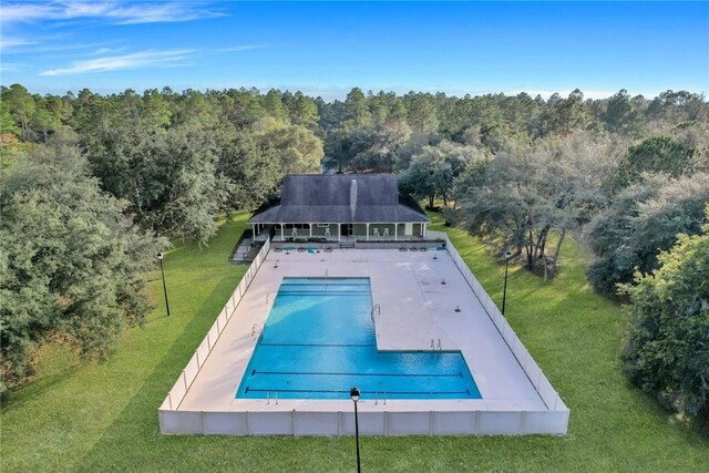 1068 Picnic Ln NE, Townsend, GA 31331 - pool featuring a lawn, a forest view, and a patio area