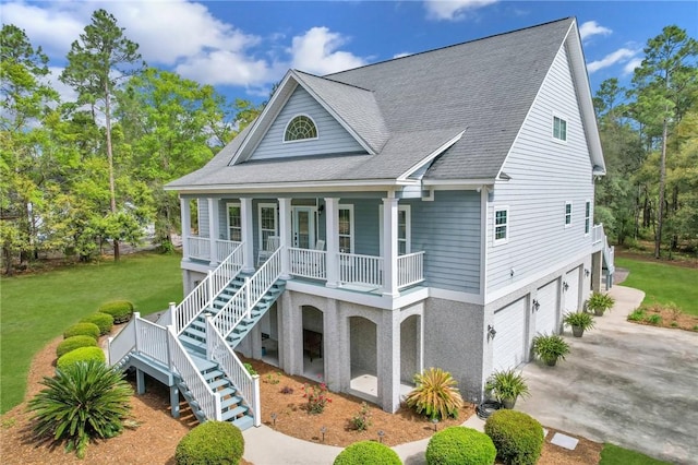 1068 Picnic Ln NE, Townsend, GA 31331 - view of front of property with roof with shingles, driveway, covered porch, a garage, and stairway