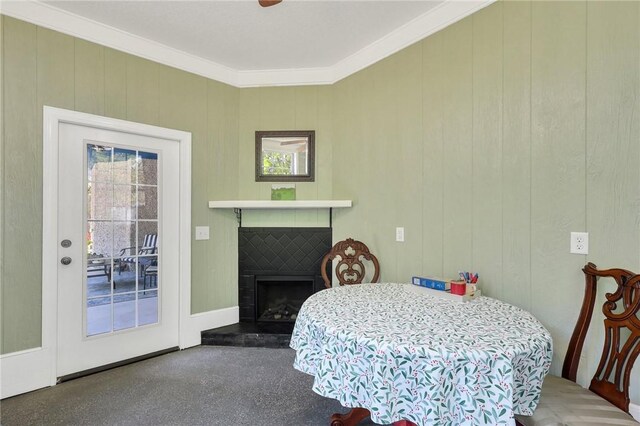 1068 Picnic Ln NE, Townsend, GA 31331 - dining area with crown molding and a fireplace with raised hearth