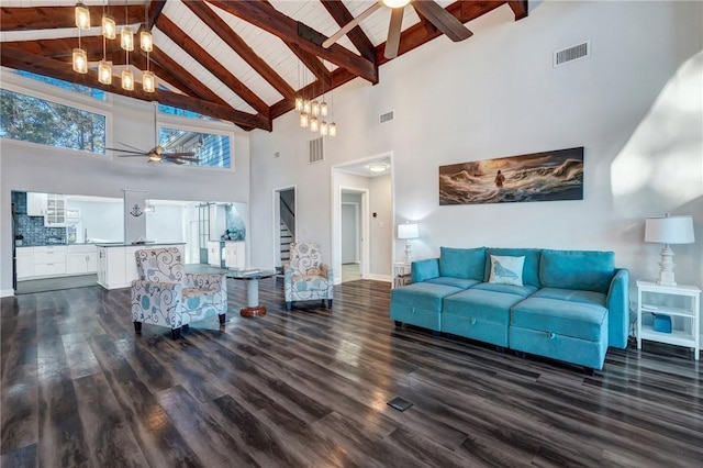 living room with lofted ceiling with beams, dark hardwood / wood-style floors, ceiling fan with notable chandelier, and wooden ceiling