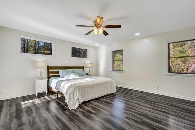 bedroom with dark hardwood / wood-style floors and ceiling fan