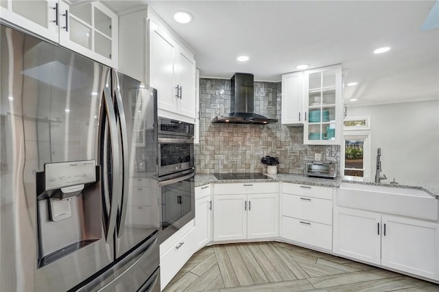 kitchen featuring white cabinetry, sink, wall chimney exhaust hood, and appliances with stainless steel finishes