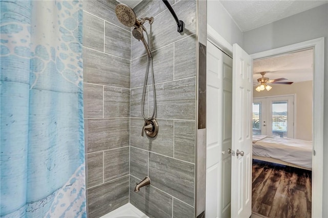 bathroom with hardwood / wood-style floors, shower / bath combination with curtain, a textured ceiling, and french doors