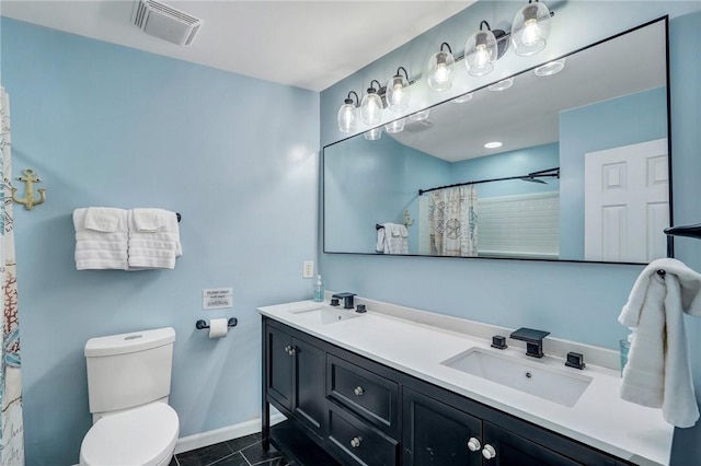 bathroom with vanity, curtained shower, tile patterned floors, and toilet