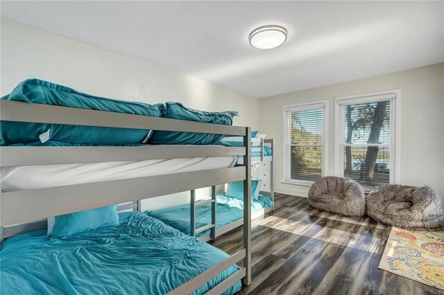 bedroom with dark hardwood / wood-style floors