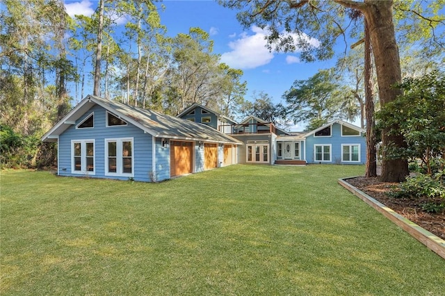 back of house featuring a yard and french doors