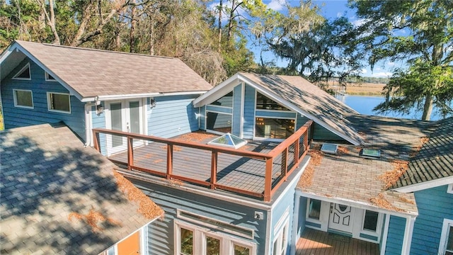 exterior space featuring a deck with water view and french doors