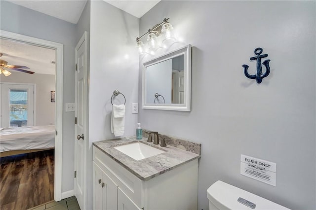 bathroom with ceiling fan, vanity, and toilet