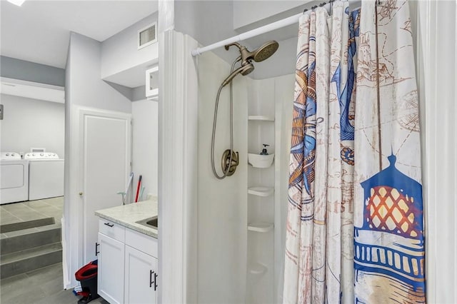 bathroom with washing machine and dryer, vanity, and a shower with shower curtain