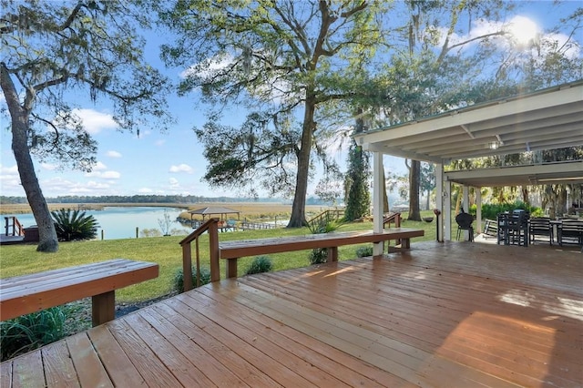 wooden deck with a water view and a yard