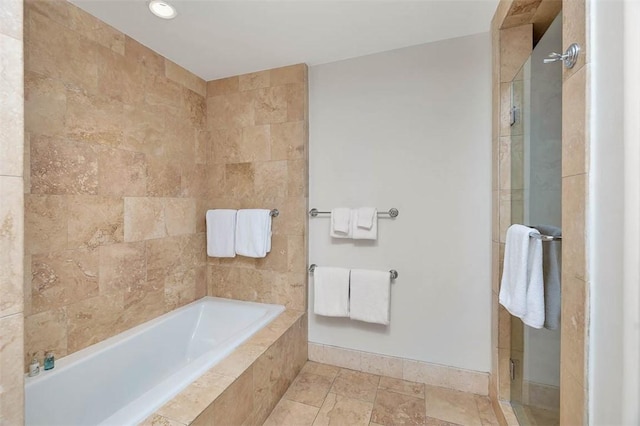 600 Beach Club Dr Unit 623/624, Sea Island, GA 31561 - full bath featuring a tile shower, a garden tub, and stone finish floors