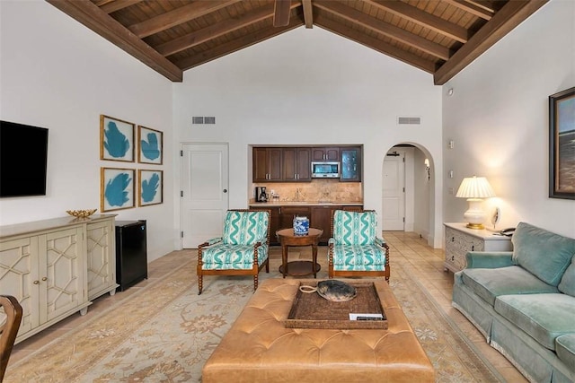 living room with beam ceiling, wood ceiling, and high vaulted ceiling