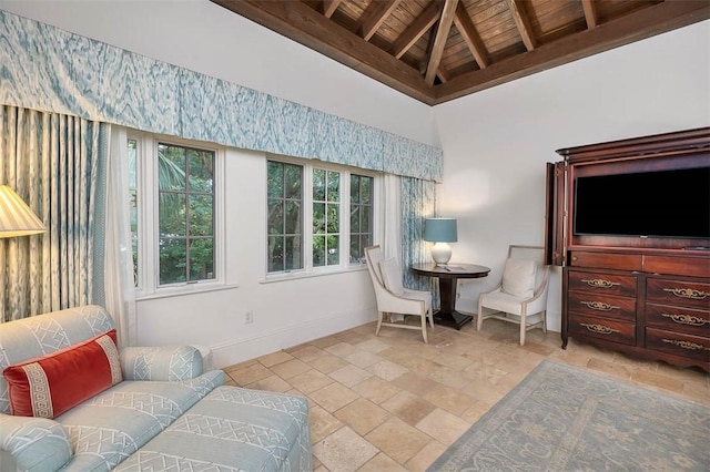 living area with lofted ceiling with beams and wooden ceiling