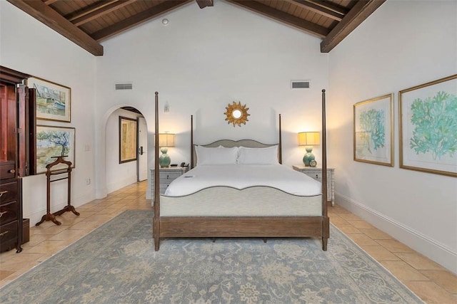 tiled bedroom featuring beam ceiling, high vaulted ceiling, and wood ceiling