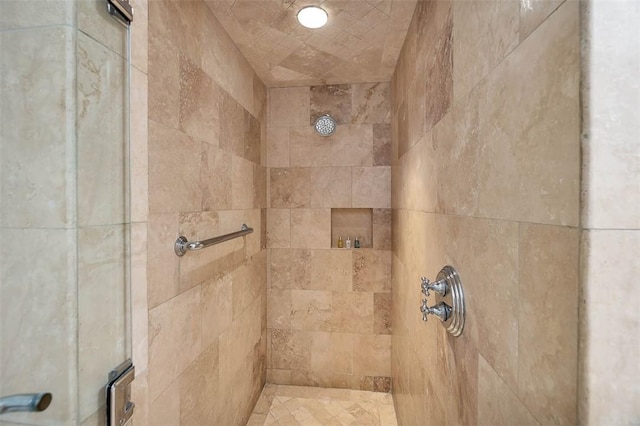 bathroom with a tile shower