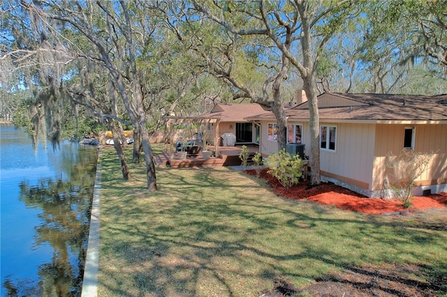 105 Driftwood Pl, Saint Simons Island, GA 31522 - view of grassy yard featuring a deck with water view and central AC