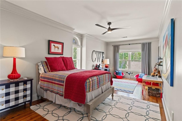 50 Frederica Oaks Ln, Saint Simons Island, GA 31522 - bedroom with wood finished floors, crown molding, baseboards, and ceiling fan