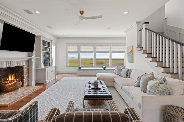 50 Frederica Oaks Ln, Saint Simons Island, GA 31522 - living room with a ceiling fan, crown molding, a fireplace, wood finished floors, and stairway