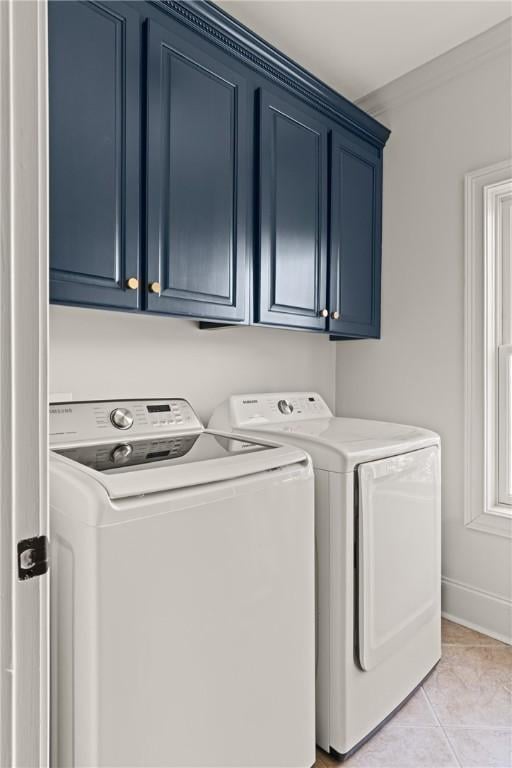50 Frederica Oaks Ln, Saint Simons Island, GA 31522 - laundry room with washing machine and clothes dryer, cabinet space, baseboards, and light tile patterned floors