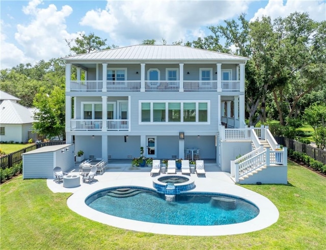 50 Frederica Oaks Ln, Saint Simons Island, GA 31522 - back of property with a balcony, a patio area, an outdoor fire pit, and a pool with connected hot tub