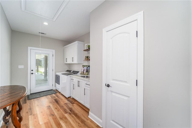 121 Farms Edge Rd S, Manor, GA 31550 - kitchen with washing machine and clothes dryer, light wood finished floors, white cabinetry, light countertops, and open shelves
